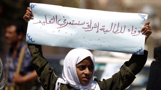 Demonstrating outside the UN office in Sanaa, a girl holds a banner saying: