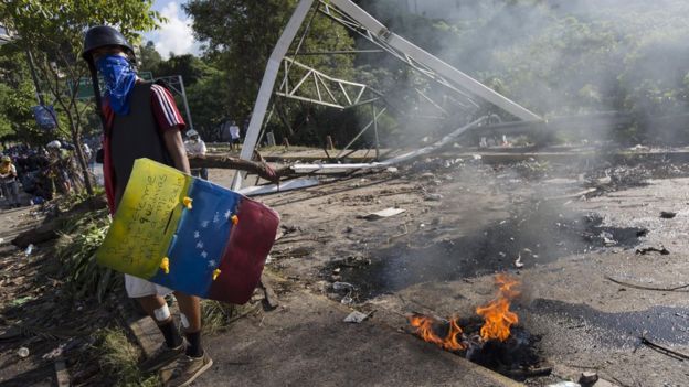 Opposition protesters block a street during a protest held to denounce the National Constituent Assembly elections, in Caracas, 30 July 2017