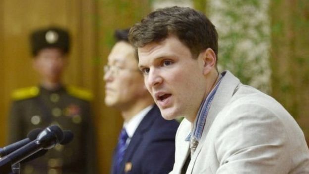 Otto Warmbier xuất hiện trong một buổi họp báo năm 2016 và thú nhận đã lấy trộm một áp phích tuyên truyền.