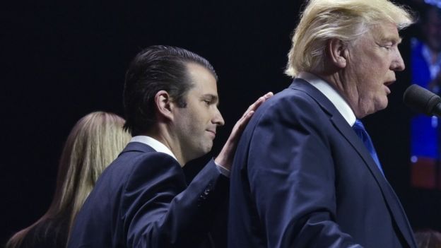 Donald Trump Jnr puts his hand on the back of presidential nominee Donald Trump on final night of US election