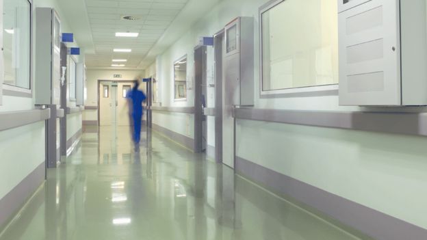 Man running down corridor in hospital
