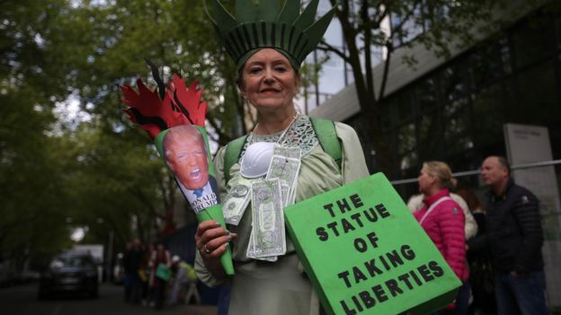 A woman protestor holding signs