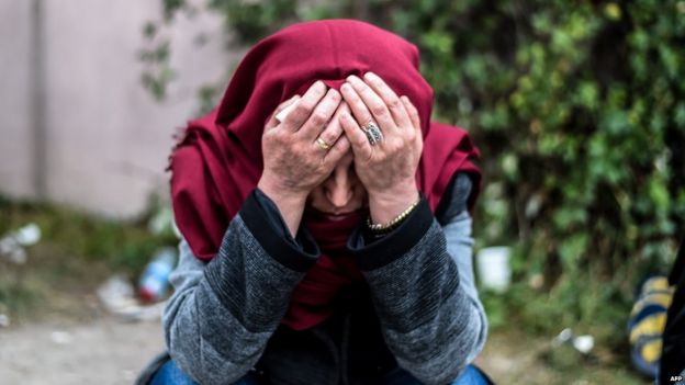 A woman waits outside the forensic morgue in Ankara, 11 October