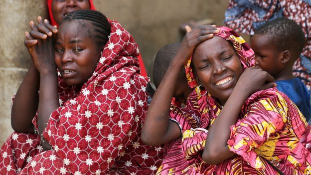 Two women sob in Dapchi. Nigeria