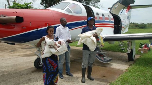 The twins and family after being flown back to their region