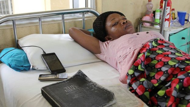 A victim of the collapsed Reigners Bible Church International building receives treatment at the university teaching hospital in Uyo, Nigeria, 12 December