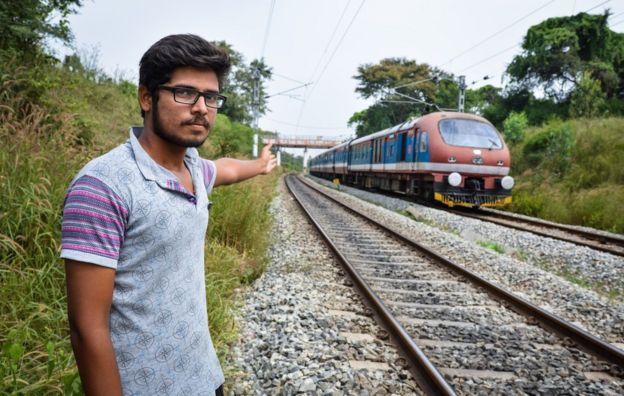 Engineering student Sharad Gowda points to the spot where three students were run over by a train while taking selfies