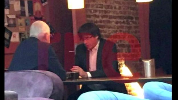 Screengrab with watermark shows Carles Puigdemont in a Belgian cafe on the day he was due in Madrid