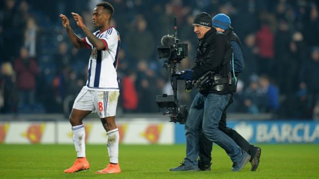 A cameraman follows a West Brom player after a Premier League game