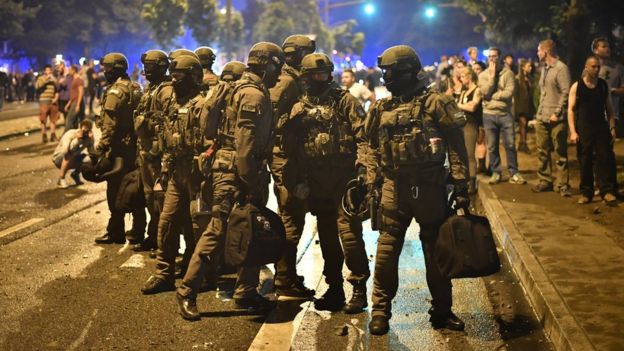 Members of a SWAT team move into the Schanze Area where protesters set up burning barricades and looters broke into stores during an anti-G20 protest in Hamburg, Germany, 7 July 2017