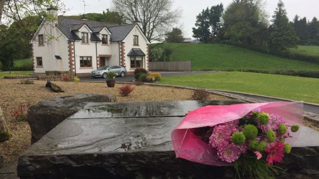 A floral tribute has been placed outside the grounds of the house where Mrs Leonard lived