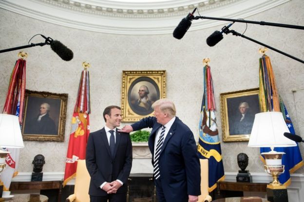 Mr Trump wipes away "dandruff" from Mr Macron's shoulder