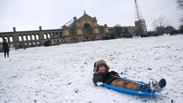 Nekko Sammann sledges in the snow at Alexandra Palace in north London, 17 January 2016.