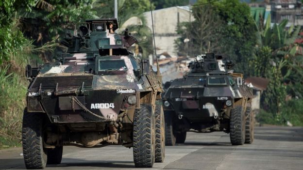 Armoured personnel carriers drive down a village road in Marawi, on the southern island of Mindanao