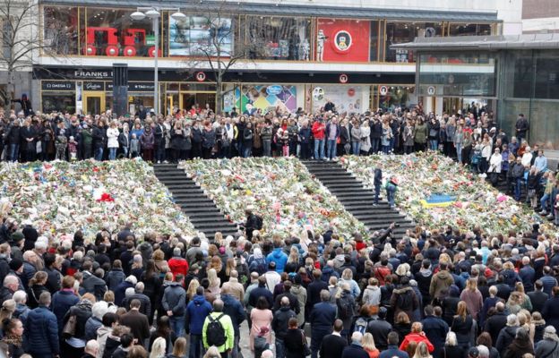 People observe a minute of silence at noon on Sergels Torg to remember the victims of Friday