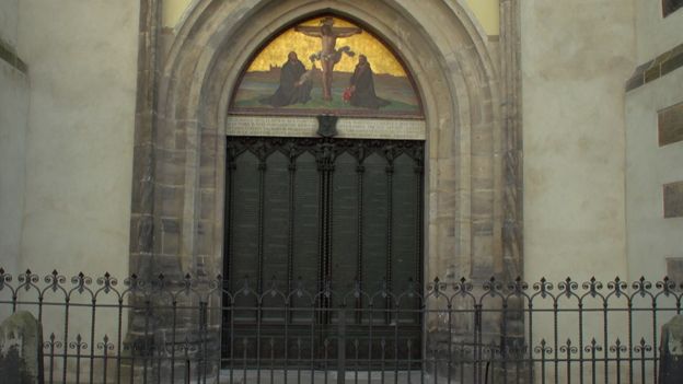 Heavy church doors with picture of Christ above