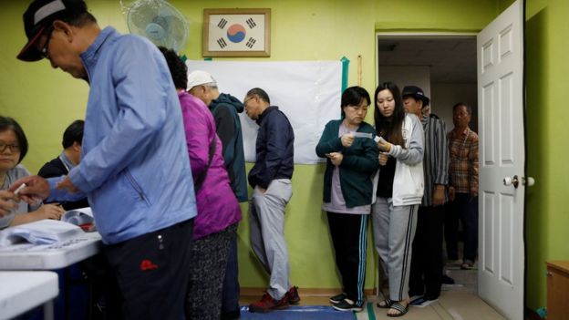 People cast their votes at a polling station during the presidential elections in Seoul, South Korea May 9, 2017