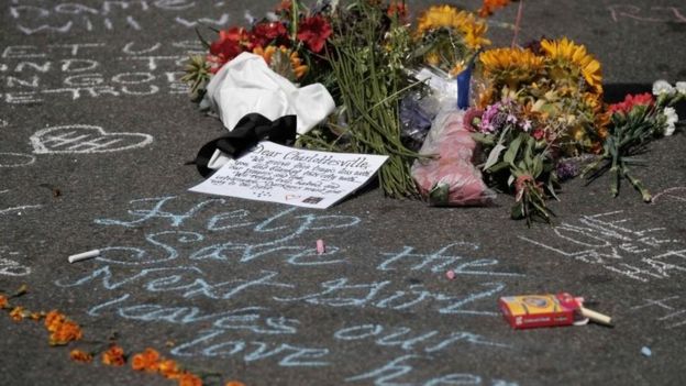 Flowers lie at a makeshift memorial a day after a car hit counter-protesters in Charlottesville, Virginia, 13 August 2017.