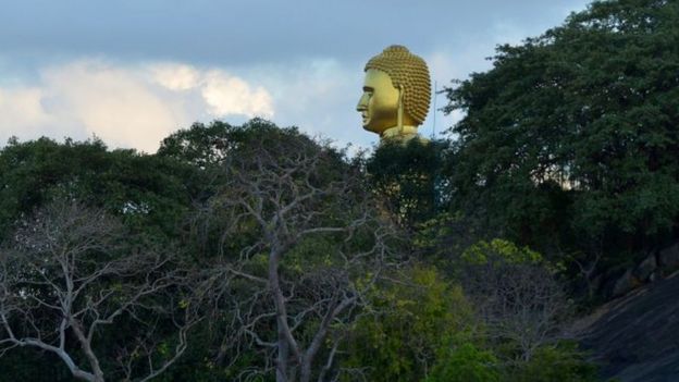 A Golden Buddha statue towers at the Rock Temple, also known as the A Golden Buddha statue towers at the Rock Temple, also known as the Rangiri Dambulla Rajamaha Viharaya, in Dambulla, some 150 kms north of Colombo, in Dambulla, some 150 kms north of Colombo