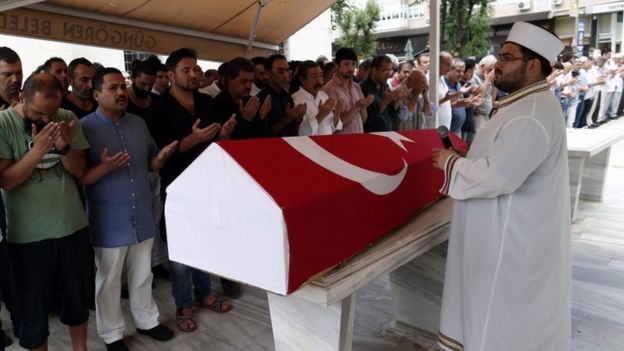 Relatives of Siddik Turgan, a customs officer at Ataturk airport, attend his funeral