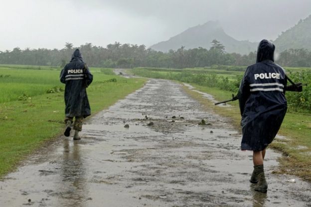 Myanmar police officers patrol a road in northern Rakhine, 26 August