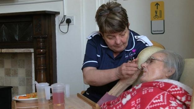 Sue Gregory caring for a resident at her care home
