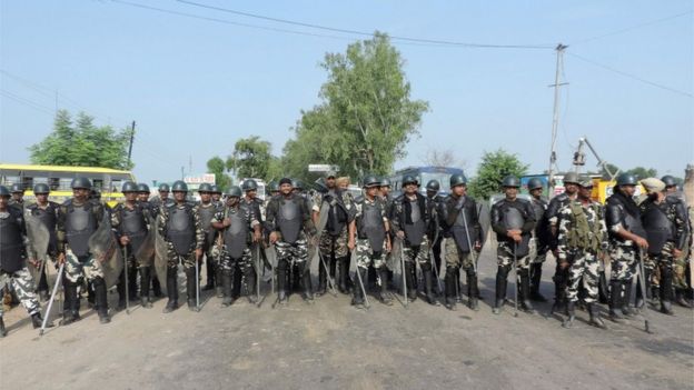 Indian police in riot gear gather to confront followers of Gurmeet Ram Rahim Singh, the controversial head of religious sect Dera Sacha Sauda (DSS), in his home base town of Sirsa on 25 August 2017