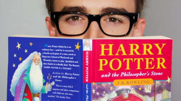 Reader with first Harry Potter book
