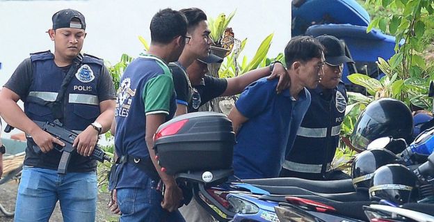 A North Korean man (second right) identified by the Malaysian police as Ri Jon-chol is taken to a police station in Sepang, Malaysia, February 18, 2017.