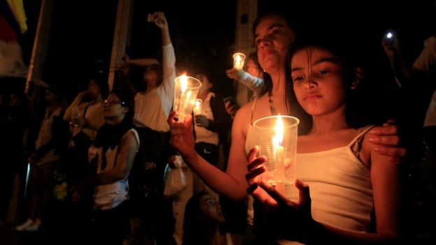 Supporters of the peace deal signed between the government and the Revolutionary Armed Forces of Colombia (FARC) rebels holds candles during a 