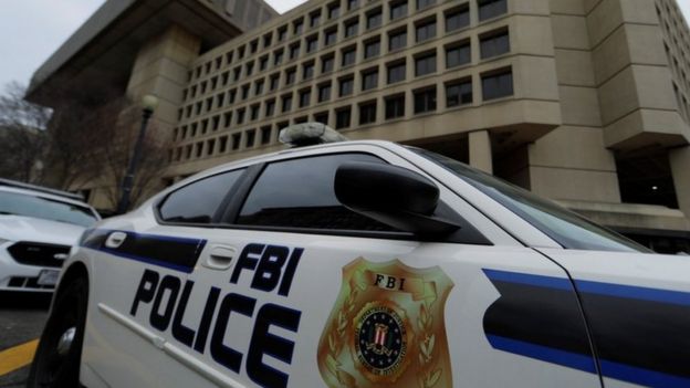 FBI police vehicles sit parked outside of the J Edgar Hoover Federal Bureau of Investigation Building in Washington, 1 February 2018
