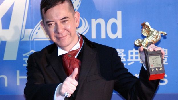Hong Kong movie star Anthony Wong displays a trophy after winning the Best Supporting Actor at Keelung Culture Center 13 November 2005