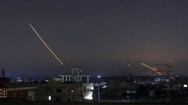 Syrian military air defence batteries lit up the night sky over the southern city of Deraa
