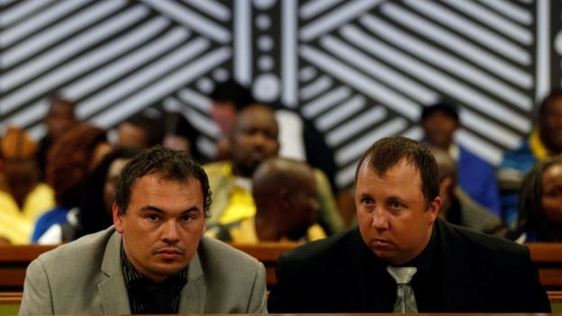 Willem Oosthuizen and Theo Martins look on during their court appearance in connection with forcing a black South African into a coffin and threatening to douse him in petrol and burn him alive, at a high court in Delmas, Mpumalanga province, South Africa, July 31, 2017