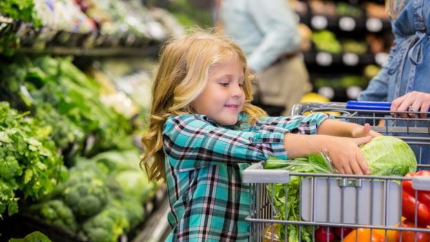 child in the veg aisle