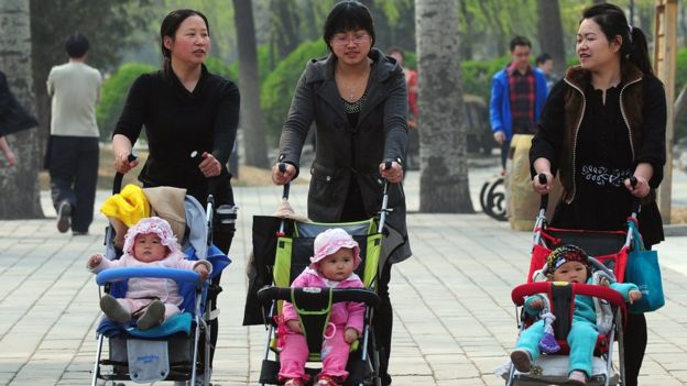 A group of mothers with their children take a stroll in Beijing