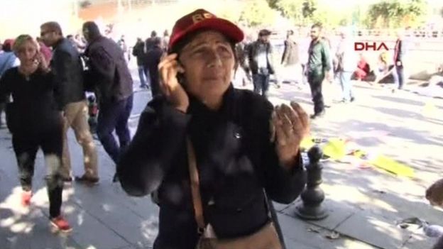 Woman talks on phone after blast in Ankara