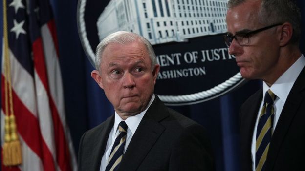 Jeff Sessions (left) looks at Andrew McCabe during a July 2017 news conference