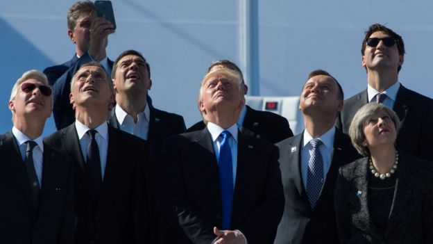 King Philippe of Belgium, NATO Secretary General Jens Stoltenberg, Greek Prime Minister Alexis Tsipras, US President Donald Trump, Poland's President Andrzej Duda, Britain's Prime Minister Theresa May and Canada's Prime Minister Justin Trudeau watch planes flying during the handover ceremony of the new headquarters of NATO (North Atlantic Treaty Organization) in Brussels, on May 25, 2017.