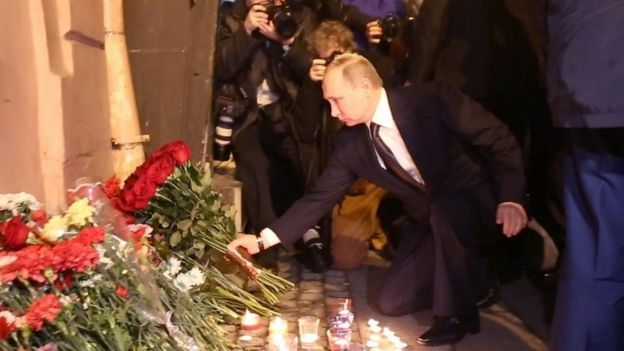 Russian President Vladimir Putin places flowers in memory of victims of the blast in the Saint Petersburg metro outside Technological Institute station on April 3, 2017