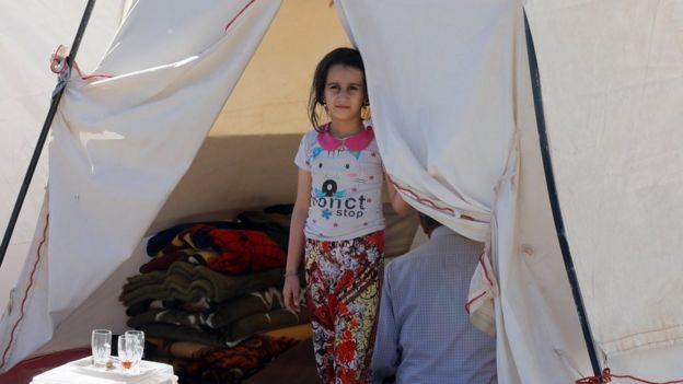 girl looking out from tent