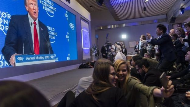 Participants watch the appearance of US President Donald J. Trump on screen from an adjacent room, during the 48th Annual Meeting of the World Economic Forum (WEF) in Davos, Switzerland, 26 January 2018