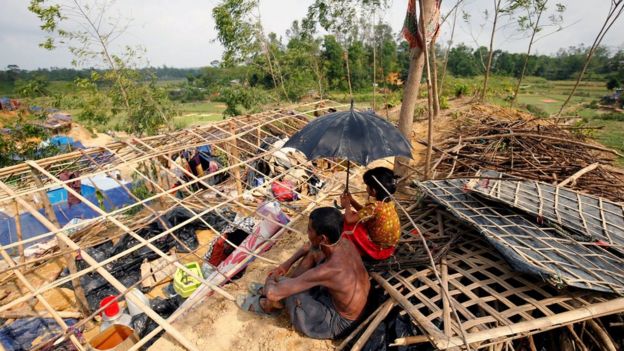 Rohingya refugees sit in front of their house which has been destroyed by Cyclone Mora at the Balukhali Makeshift Refugee Camp in Cox's Bazar, Bangladesh 31 May 2017