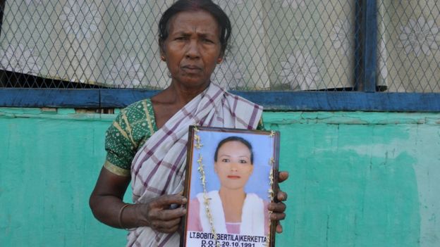 Mariam Kerketta holds a photo of her daughter Bobita