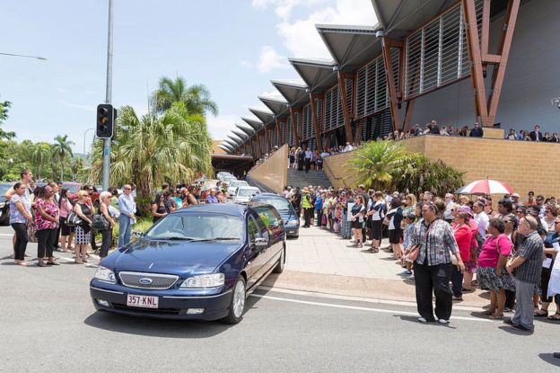 Mourners line a funeral procession for the eight children in Cairns