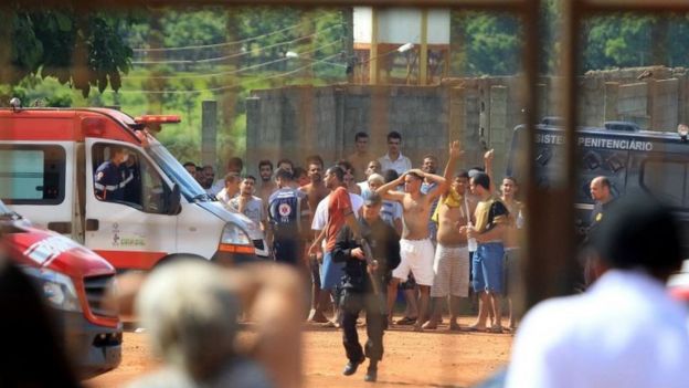 A handout photo made available by O Popular shows a group of inmates guarded by the authorities at a prison in the metropolitan region of Goiania, capital of the Brazilian state of Goias, Brazil, 01 January 2018.