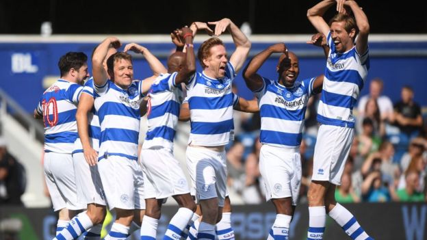 Players in the Game4Grenfell football match celebrate Sir Mo Farah's goal