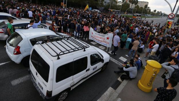 Students block a street during a gathering to protest against the imprisonment of leaders of two of the largest Catalan separatist organisations