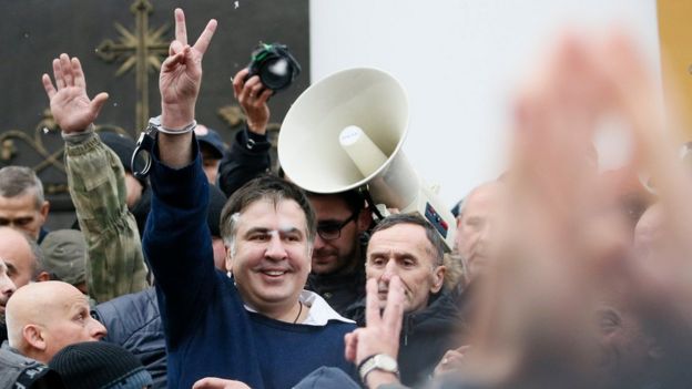 Georgian former President Mikheil Saakashvili flashes a victory sign after he was freed by his supporters in Kiev