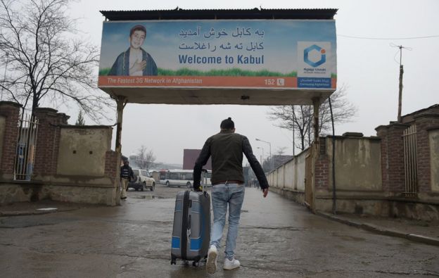 An Afghan refugee who was deported from Germany arrives with his belongings at the international airport in Kabul on January 24, 2017.